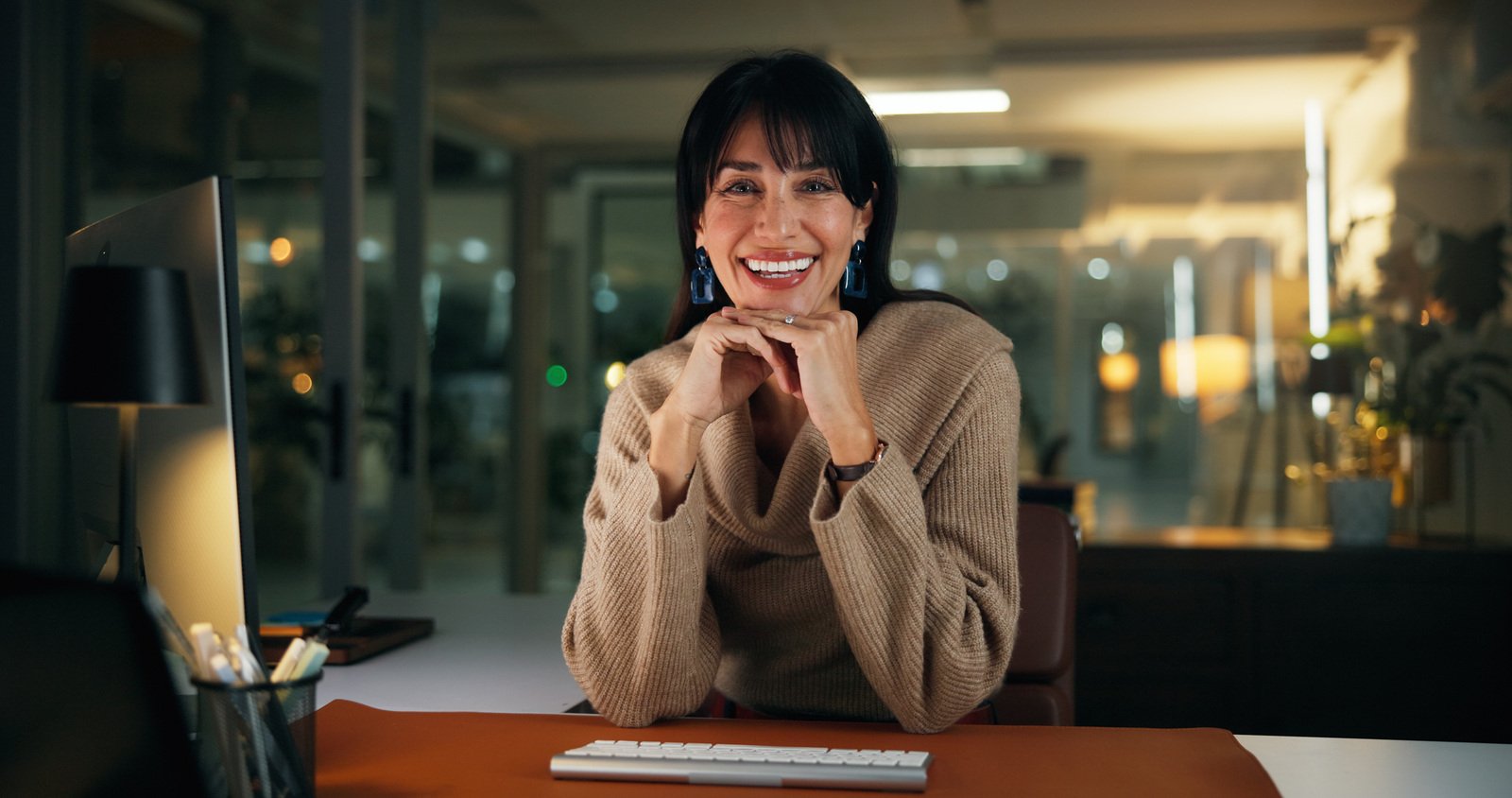 Mulher sorrindo em seu ambiente de trabalho